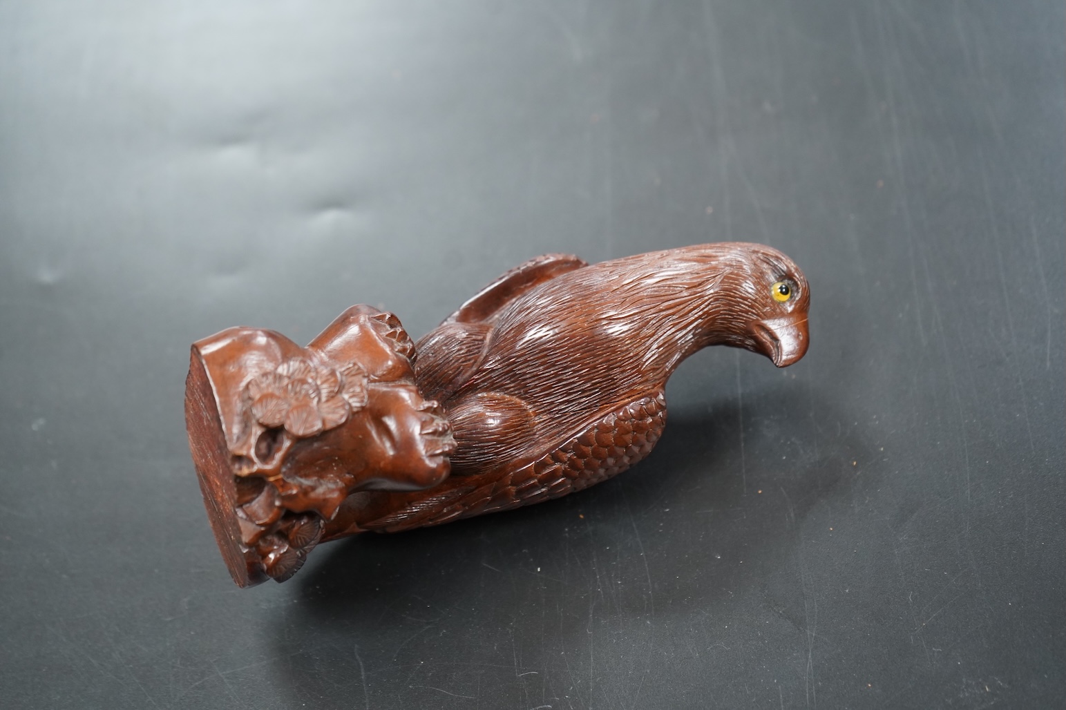 A Chinese rosewood carving of a hawk on base, with inlaid glass eyes, 13cm high